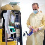 HELPING HAND: John Schreiber is one of about 50 travel nurses who have been hired temporarily to fill open positions at Kent County Memorial Hospital in Warwick. The use of travel nurses at hospitals has increased because of a labor shortage. / COURTESY CARE NEW ENGLAND HEALTH SYSTEM/RYAN PICKERING