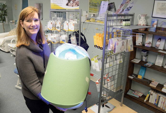 BRIGHT IDEA: Kathleen Moren, Healthy Babies, Happy Moms Inc. president, displays phototherapy equipment that allows nurses from her company to treat babies with jaundice at home rather than in a hospital. / PBN FILE PHOTO/ELIZABETH GRAHAM