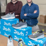 NEW SHOES: Joshua Swift, left, and David Maceroni, in their East Providence warehouse where they receive and ship out shoes for their new company, Dash Running LLC. / PBN PHOTO/MICHAEL SALERNO