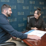 TITLE TALK: Diep Nguyen, right, managing member of Elite Title & Closing Services LLC in East Providence, meets with Robert Watson, associate ­attorney. / PBN FILE PHOTO/MICHAEL SALERNO