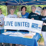 GOOD READING: United Way of Rhode Island Inc. employees attend a recent outdoor event to promote reading for children. / COURTESY UNITED WAY OF RHODE ISLAND INC.