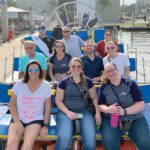 ON THE WATER: Staffers at Landings Management LLC enjoy a boat ride at a recent company outing. / COURTESY LANDINGS MANAGEMENT LLC