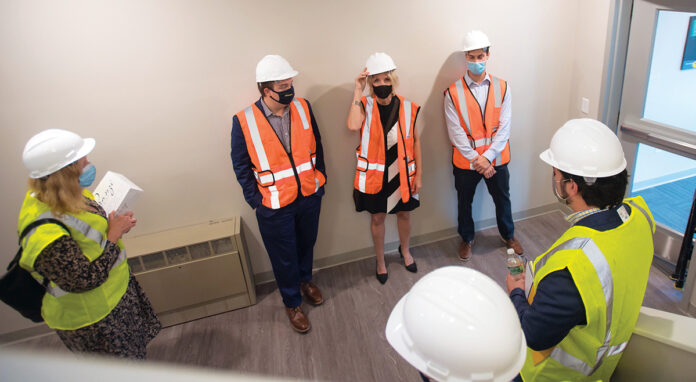 SAFETY FIRST: Staffers for R.I. Housing and Mortgage Finance Corp. prep to work at a project site. / COURTESY R.I. HOUSING AND MORTGAGE FINANCE CORP.