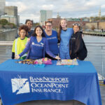 SWEET EVENING: BankNewport employees distribute candy as part of a Halloween event on the pedestrian bridge in Providence. / COURTESY BANKNEWPORT