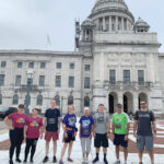 PACESETTERS: Staffers from Navigant Credit Union pose in front of the R.I. Statehouse before participating in the annual Providence Downtown 5K. / COURTESY NAVIGANT CREDIT UNION
