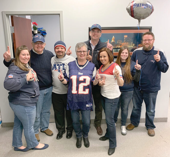 PATRIOTS PRIDE: Employees at Secure Future Tech Solutions wear New England Patriots attire as part of the company’s Patriots Spirit Day.  COURTESY SECURE FUTURE TECH SOLUTIONS