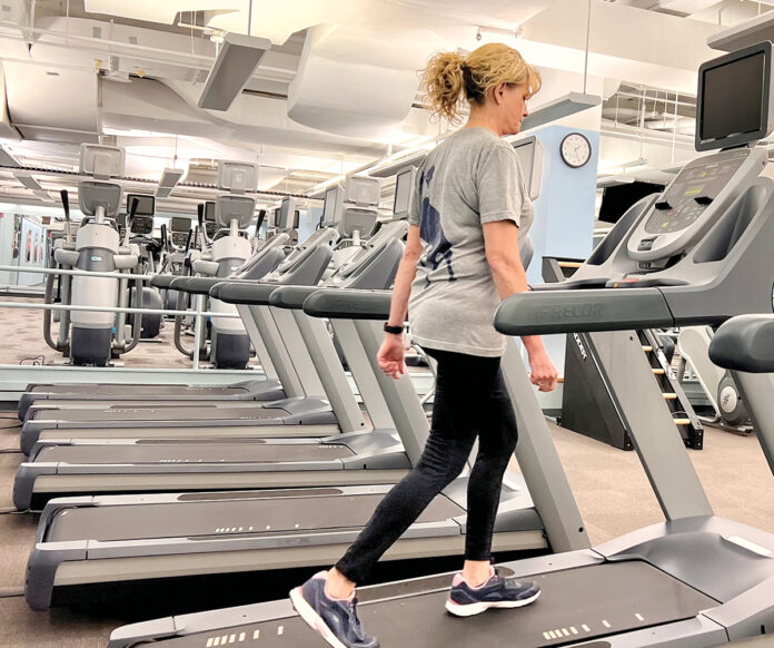 TREADING ALONG: CVS Health Corp. employee Diana Balavender works out on a treadmill at one of the company’s on-site fitness centers.  COURTESY CVS HEALTH CORP. 