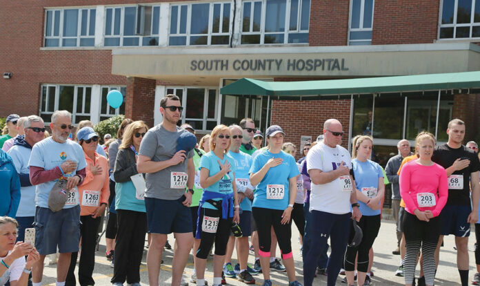 ON YOUR SIGNS: South County health workers gather in front of South County Hospital in South Kingstown as they prepare to kick off South County's 5th health centenary 5K in May 2019. Courtesy South County Health