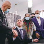 DECISION TIME: Providence Mayor Jorge O. Elorza, seated, and the City Council must decide on $10 million in recommended spending for the city’s racial reparations program. Elorza is pictured in February at the announcement of his creation of a panel that has made spending recommendations for the program.  COURTESY CITY OF PROVIDENCE