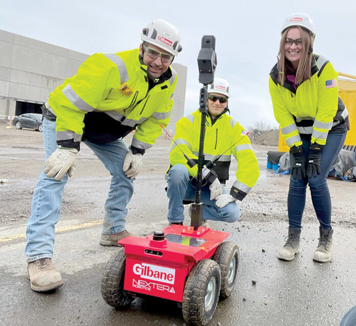 MOBILE PARTNER: From left, Gilbane Inc. Lead Superintendent Chris Pielech, construction intern Nick Shurling and project engineer Lauren Muldoon pose with an autonomous mobile robot.  COURTESY GILBANE INC.