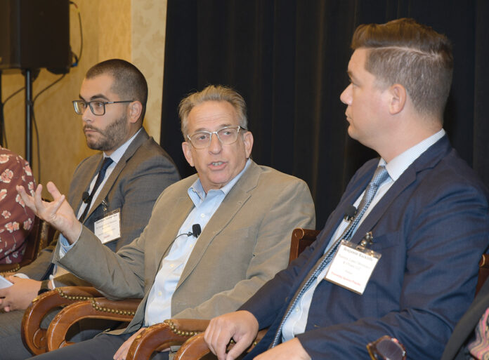 LAYING DOWN THE LAW: State Sen. Joshua Miller, D-Cranston, second from right, discusses a new Rhode Island law legalizing recreational marijuana use and its retail sales. Also on one of two panels at Providence Business News’ 2022 Business of Cannabis summit on Sept. 15 are, from left, Matthew Santacroce, R.I. Department of Business Regulation interim director; and Benjamin L. Rackliffe, a partner at Pannone Lopes Devereaux and O’Gara LLC. PBN PHOTO/MIKE SKORSKI