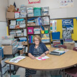 CRAMPED CLASSROOM: Thornton Elementary School Principal Louise Denham sits in one of the school’s cramped classrooms. The building is more than 100 years old and is part of a plan to consolidate all four elementary schools in Johnston using a voter-approved $215 million school construction bond.  PBN PHOTO/MICHAEL SALERNO  