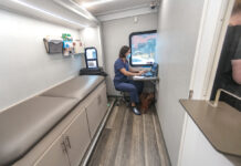 DOCTOR IS IN: Dr. Francesca Beaudoin works on her computer in an exam room inside CODAC Behavioral Healthcare’s new mobile treatment unit for opioid addiction. PBN PHOTO/MICHAEL SALERNO