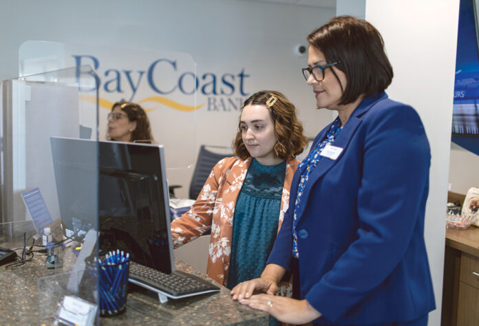 MONEY TALKS: Amy Hernandez, right, manager of BayCoast Bank’s downtown Providence branch on Dorrance Street, speaks with universal banker Bianca Gouveia.   PBN PHOTO/RUPERT WHITELEY