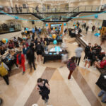 BRYANT UNIVERSITY STUDENTS help with on-campus donations inside the rotunda Wednesday during the university's annual Giving Day. The initiative raised more than $2 million, setting a new record. / COURTESY BRYANT UNIVERSITY