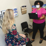 VITAL SERVICE: Ashlee Austin, right, site inclusive health clinician at Thundermist Health Center, meets with a patient at the  center’s West Warwick location. PBN PHOTO/ELIZABETH GRAHAM