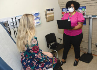 VITAL SERVICE: Ashlee Austin, right, site inclusive health clinician at Thundermist Health Center, meets with a patient at the  center’s West Warwick location. PBN PHOTO/ELIZABETH GRAHAM