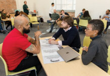 BUILDING THE FUTURE: College Unbound Director of Admissions Jose Rodriguez, left; co-founder, Provost and President Adam Bush; and Sylvia Spears, vice president for administration and innovation, talk during a work session at the Providence nonprofit.  PBN PHOTO/TRACY JENKINS