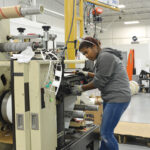 ENHANCED OPERATION: Keila Mendez, a machine operator at AstroNova Inc., works at the company’s West Warwick facility. The company, which designs, manufactures, distributes and services data visualization technologies, hired a new director of quality and continuous improvement and implemented new safety measures that have contributed to improved operations. PBN PHOTO/ELIZABETH GRAHAM