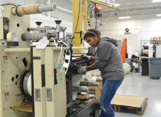 ENHANCED OPERATION: Keila Mendez, a machine operator at AstroNova Inc., works at the company’s West Warwick facility. The company, which designs, manufactures, distributes and services data visualization technologies, hired a new director of quality and continuous improvement and implemented new safety measures that have contributed to improved operations. PBN PHOTO/ELIZABETH GRAHAM