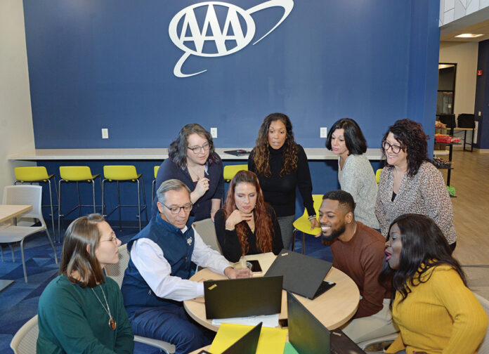 ADVANCING CAREERS: Staff members at AAA Northeast gather at the company’s Providence office. A year ago, AAA Northeast launched a career exploration program that provides a learning platform for employees of diverse backgrounds and talents who are performing well in their current roles. PBN PHOTO/ELIZABETH GRAHAM