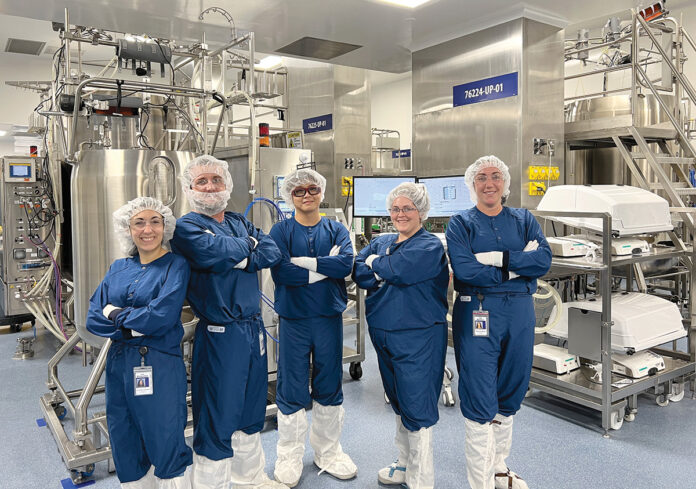 TEAMWORK: From left, Amgen Rhode Island manufacturing associate Alexandra Marzilli, senior associates Matt Miller, Jie Wen Yang and Kate Boucher, and Front Line Manager Marissa Burke work together in a section of the company’s new West Greenwich plant that employs single-use technology to manufacture drug substances. COURTESY AMGEN RHODE ISLAND