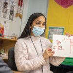 HEAD OF THE CLASS: The Rhode Island Foundation recently launched a college loan repayment program to help the Providence Public School District recruit and retain teachers of color. One participant is Maria Taveras, pictured, who is working on a math lesson with her second grade class at Fortes Lima Elementary School.  COURTESY RHODE ISLAND FOUNDATION