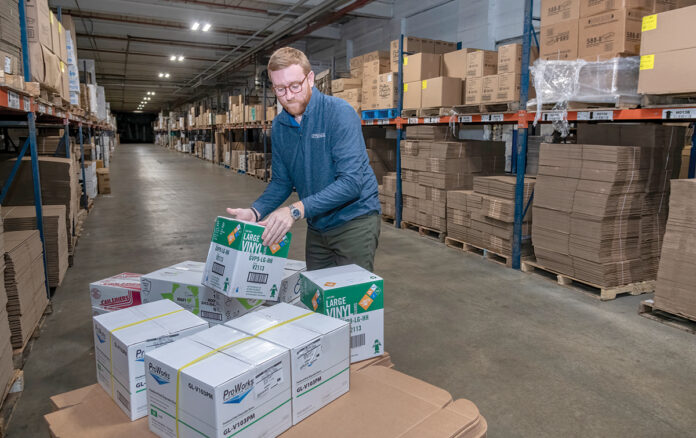 BUILDING BLOCKS: Ryan Powers, co-owner of RJP Packaging LLC, works at the company’s Pawtucket headquarters. Powers and his father, John Powers, started the business as an industrial packaging company but have expanded. PBN PHOTO/MICHAEL SALERNO