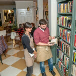LOVE OF LITERATURE: Uriah Donnelly, right, realized his dream of owning a bookstore when he and his wife, Janet Moscarello, left, opened arc{hive} book + snackery in Warren in June. PBN PHOTO/MICHAEL SALERNO