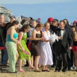 PARTICIPANTS GET READY to take the plunge at a previous WARM Center Penguin Plunge. The 17th annual plunge will take place Jan. 1 at Windjammer Surf Bar in Westerly. / COURTESY SOUTH COUNTY TOURISM COUNCIL