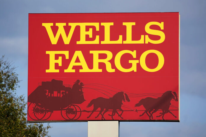 CONSUMER BANKING giant Wells Fargo must pay $3.7 billion in fines and refunds to customers, the largest fine to date against the bank. Pictured is a Wells Fargo sign in Bradenton, Fla. / AP PHOTO/GENE J. PUSKAR