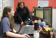 RECRUITING ­ASSISTANCE: Dawn Apajee, right, owner of staff recruiting agency City Personnel Inc., works with senior recruiter Megan Atkins at her office in Providence. PBN PHOTO/­ELIZABETH GRAHAM