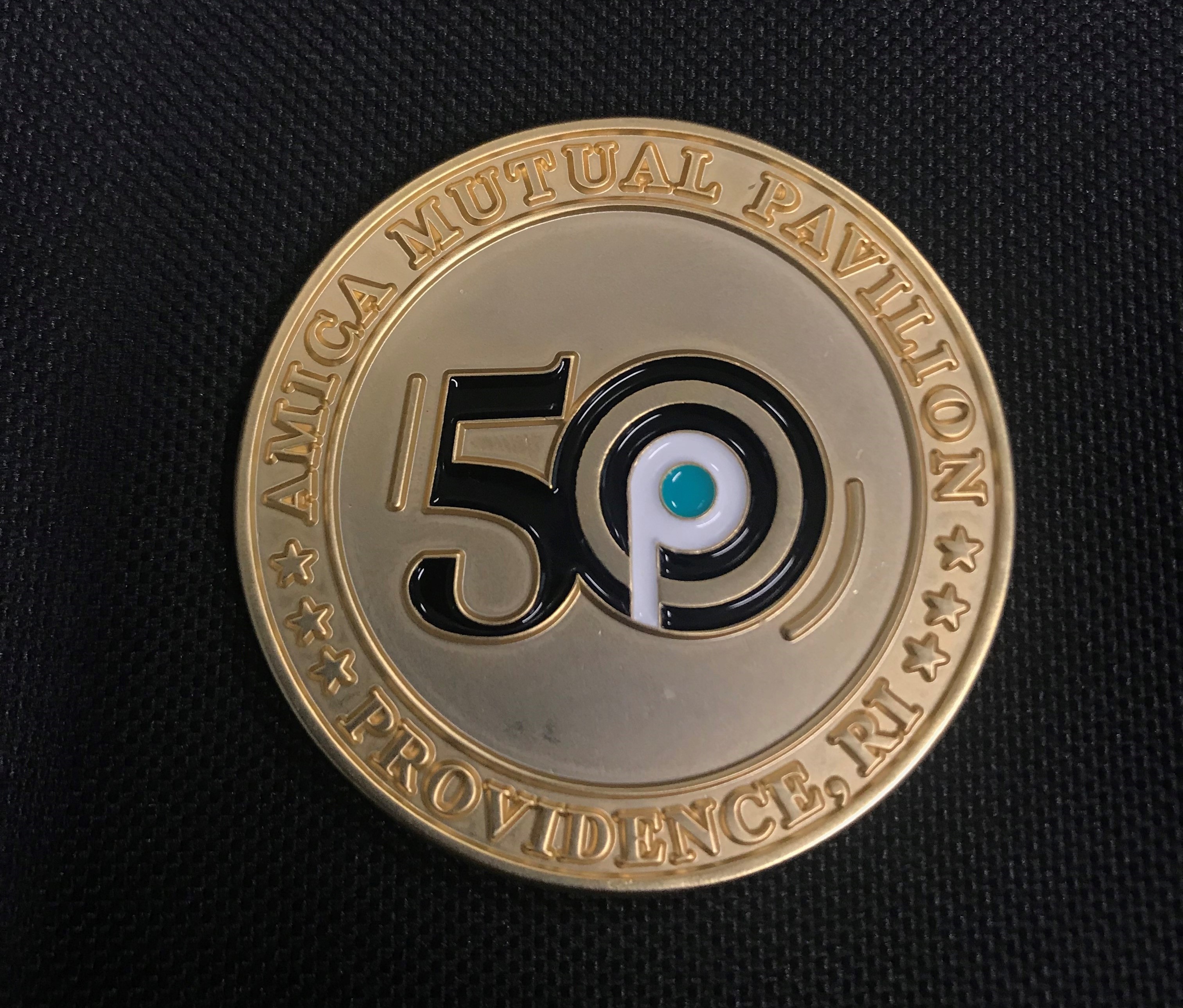 A COMMEMORATIVE COIN signifying Amica Mutual Pavilion's 50th anniversary will be utilized for promotional purposes throughout the year. / PBN PHOTO/JAMES BESSETTE