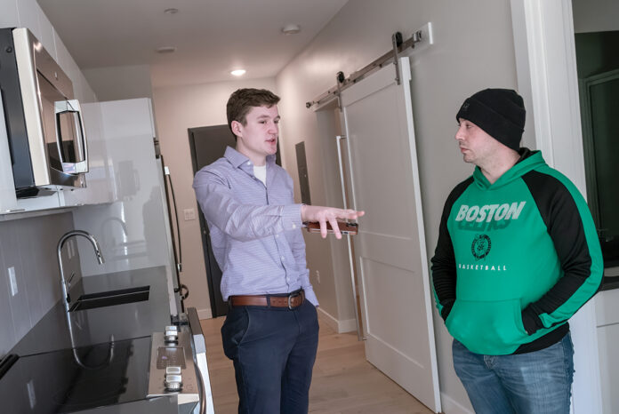 ON TOUR: Brett Bessette, left, a real estate agent with Residential Properties Ltd., shows an apartment in a newly constructed building at 500 South Water St., Providence, to a prospective tenant, John Pereira, of East ­Providence.  PBN PHOTO/ MICHAEL SALERNO