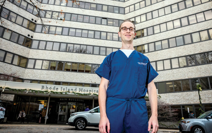 GOOD NEWS, BAD NEWS: Dr. Jared Anderson, standing outside Rhode Island Hospital, where he works as an emergency physician, says electronic health records are beneficial for care but interfaces need to be optimized so doctors aren’t spending so much time on data entry.  PBN PHOTO/MICHAEL SALERNO