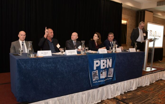 KARL WADENSTEN, second from left, CEO and president of VIBCO Inc., makes a point during the panel discussion at Providence Business News' 2023 Economic Trends Summit in Providence on Thursday. Also on the panel is, from left, Thomas Tzitouris, head of fixed income research at Stratgas; Peter R. Phillips, senior vice president and chief investment officer at Washington Trust Wealth Management; Julietta Georgakis, chief of staff for the R.I. Executive Office of Commerce; and Kevin Casey, vice president of sales at Sweeney Real Estate & Appraisal. At far right is PBN Editor Michael Mello, the moderator. / PBN PHOTO/MIKE SKORSKI