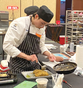 TOP CHEF: Henry Nguyen, a student at the Exeter Job Corps Center, prepares a dish during the 11th annual Rhode Island ProStart High School Culinary Arts, Foodservice & Hotel Management Competition on Feb. 7. The center’s team won first place in the Culinary Arts category. COURTESY SPENCER GOSSY