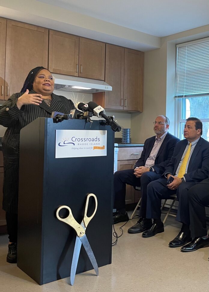 MICHELLE LEE, left, speaks during Thursday's press event cutting the ribbon-cutting event on new homeless family apartments in Warwick for Crossroads Rhode Island. Lee will become a new resident in the apartments. Also pictured are R.I. Housing Secretary Stefan Pryor, middle, and House Speaker K. Joseph Shekarchi, D-Warwick. / COURTESY CROSSROADS RHODE ISLAND