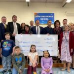 STATE AND EDUCATION OFFICIALS present a grant to Warwick Schools at Oakland Beach Elementary School. The state has awarded 21 grants to local education agencies and nonprofit partners totaling $3.9 million. / COURTESY GOV. DANIEL J. MCKEE