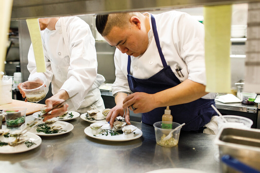 DISHING IT OUT: Castle Hill Inn executive chef Andy Taur preps the Rhode Island oysters with pear, kohlrabi and horseradish, a dish featured on the tasting menu for dinner in The Dining Room at the inn.  COURTESY CASTLE HILL INN/ERIN MCGINN