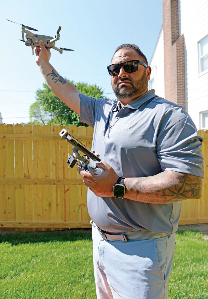 HIGHFLIER: Kyle Phillips, owner of Flyt Imaging LLC, with one of his drones at his home in Cranston. PBN PHOTO/ELIZABETH GRAHAM