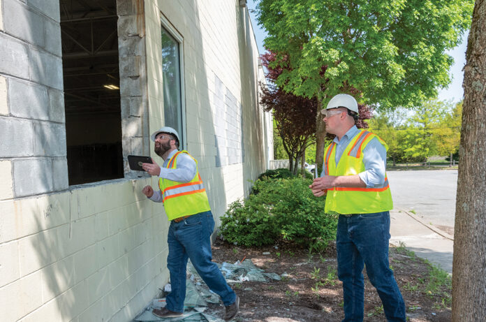 SITE VISIT: Justin Kordas, left, and William Porter, co-owners of structural engineering consulting firm Stone Fleet Inc. in Providence, visit the construction site of one of their clients.  PBN PHOTO/­MICHAEL SALERNO